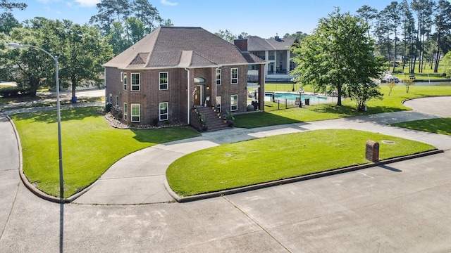 2906 Penninsula Pt, Montgomery, TX 77356 - view of front of home featuring a front yard and brick siding