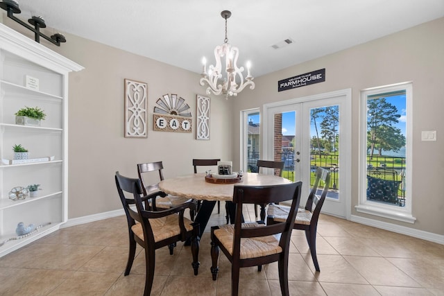 2906 Penninsula Pt, Montgomery, TX 77356 - dining room featuring french doors, a chandelier, light tile patterned floors, and built in shelves