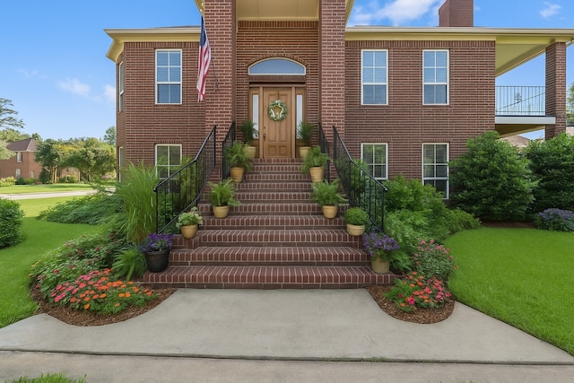 2906 Penninsula Pt, Montgomery, TX 77356 - entrance to property featuring a chimney, a lawn, and brick siding