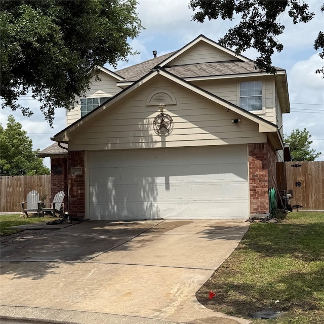 view of front of house with concrete driveway, fence, and roof with shingles