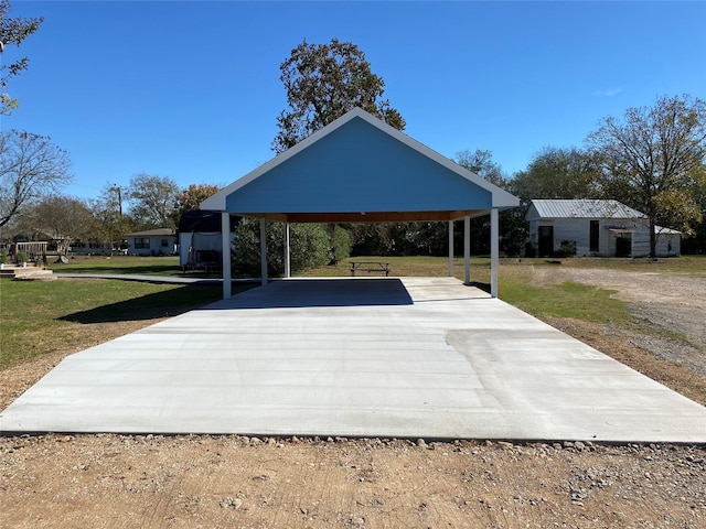 view of home's community with a yard, a carport, and concrete driveway