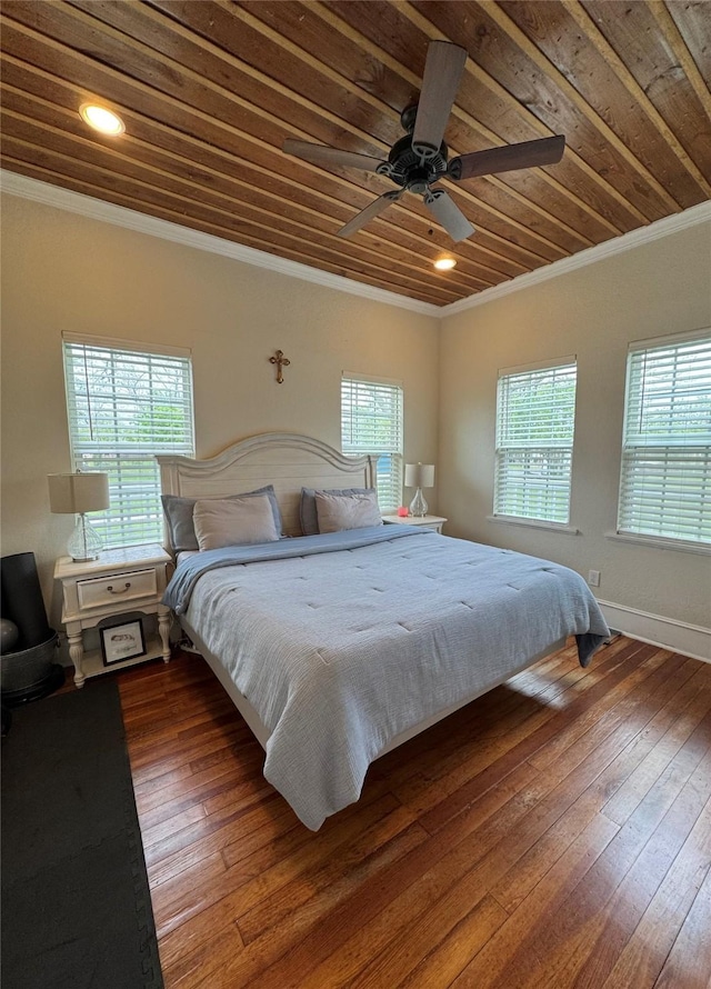 bedroom featuring wooden ceiling, dark wood-style floors, baseboards, and ornamental molding