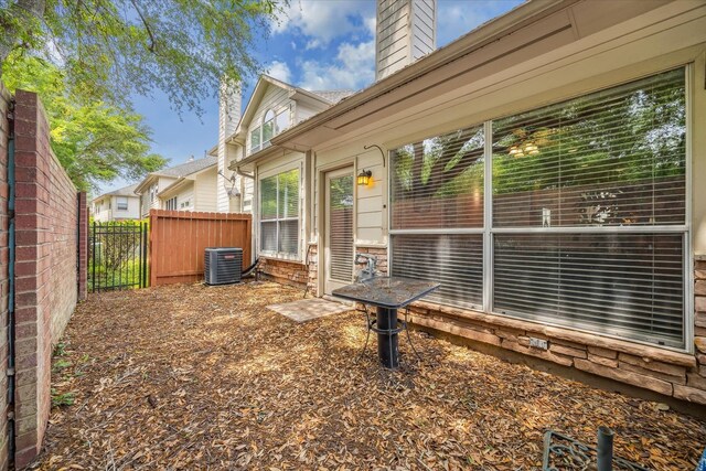 view of yard featuring cooling unit and fence