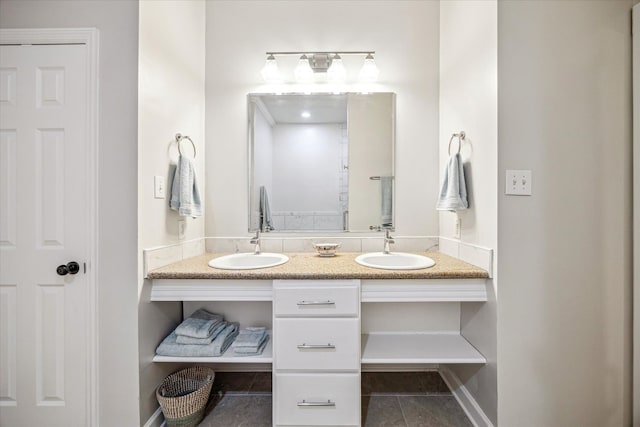 bathroom featuring tile patterned floors, double vanity, baseboards, and a sink