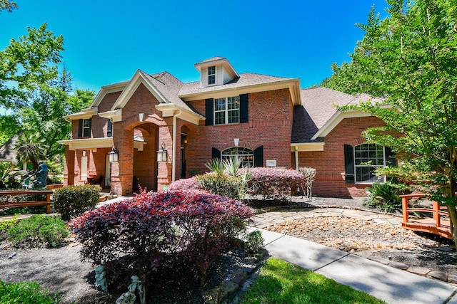 37703 Edgewater Dr, Pinehurst, TX 77362 - view of front of house featuring brick siding, roof with shingles, and fence
