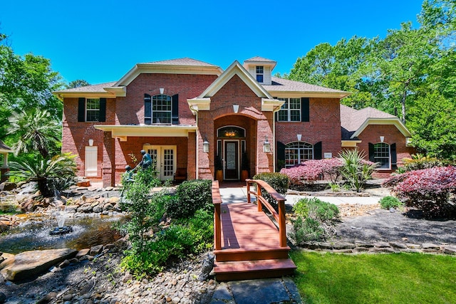 37703 Edgewater Dr, Pinehurst, TX 77362 - colonial-style house featuring brick siding