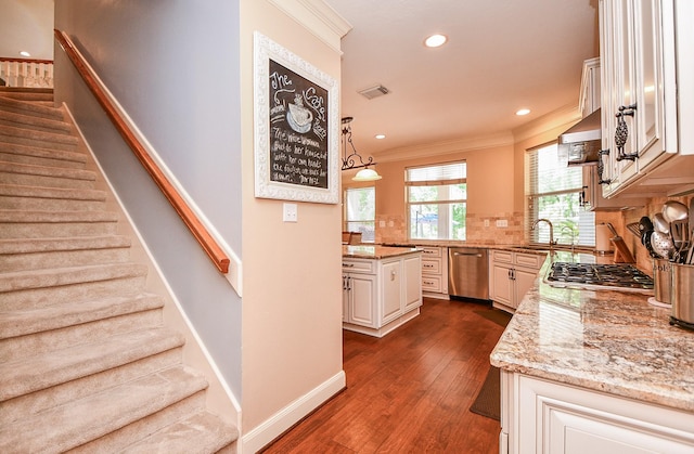 37703 Edgewater Dr, Pinehurst, TX 77362 - kitchen with appliances with stainless steel finishes, ornamental molding, light stone counters, dark wood-style flooring, and baseboards