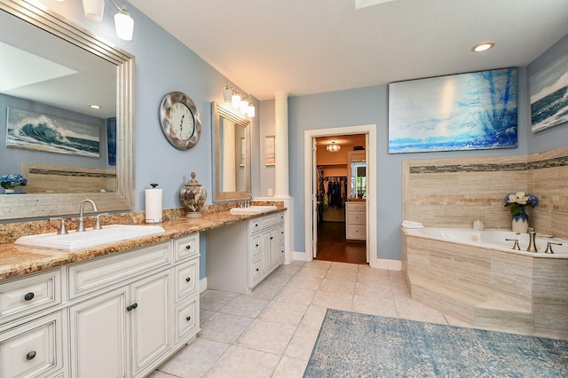 37703 Edgewater Dr, Pinehurst, TX 77362 - full bath featuring tile patterned flooring, double vanity, a bath, a spacious closet, and baseboards