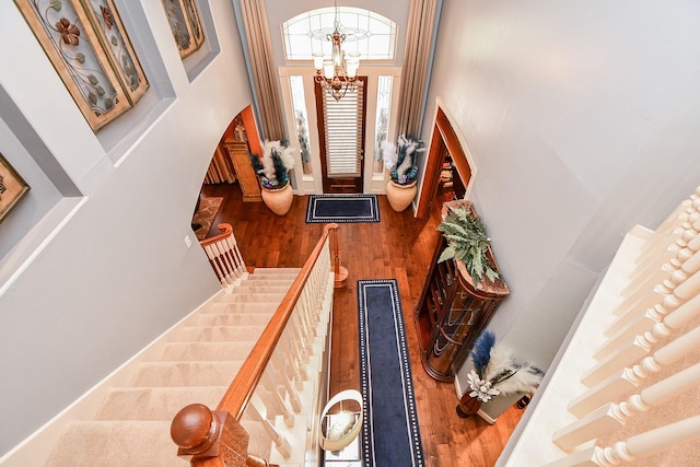 37703 Edgewater Dr, Pinehurst, TX 77362 - entrance foyer with wood finished floors, a chandelier, and a high ceiling