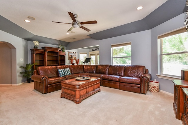 37703 Edgewater Dr, Pinehurst, TX 77362 - living area featuring light colored carpet, a ceiling fan, arched walkways, healthy amount of natural light, and recessed lighting