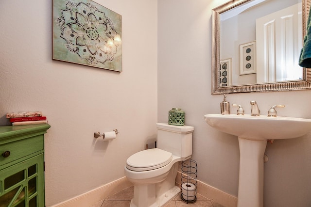37703 Edgewater Dr, Pinehurst, TX 77362 - bathroom featuring tile patterned flooring, toilet, baseboards, and a sink