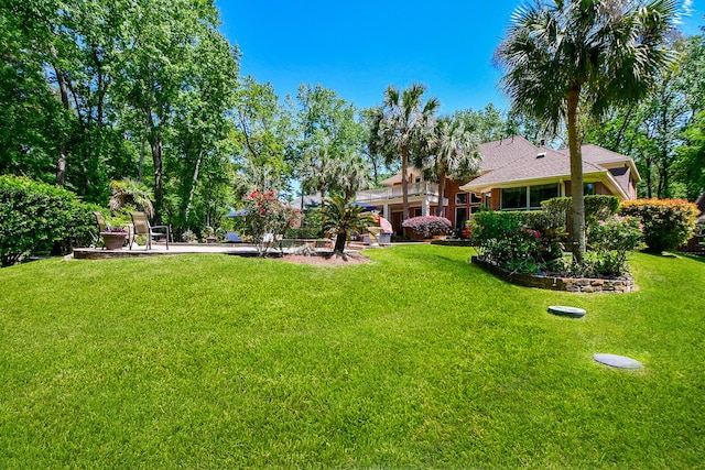 37703 Edgewater Dr, Pinehurst, TX 77362 - view of grassy yard featuring a patio