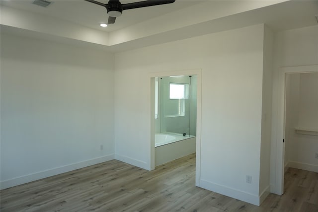 interior space with visible vents, baseboards, light wood finished floors, and ceiling fan