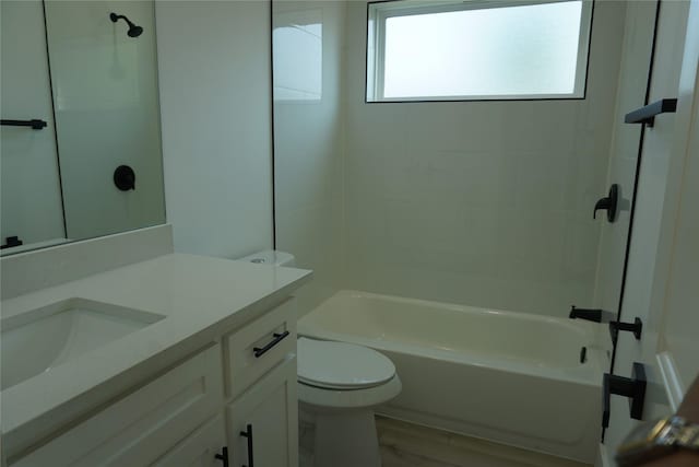 bathroom with shower / washtub combination, vanity, toilet, and wood finished floors