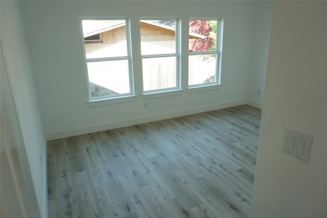 empty room with wood finished floors and baseboards