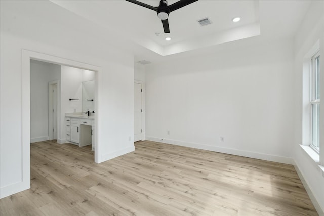 6319 Ivyknoll Dr, Houston, TX 77035 - empty room with ceiling fan, light wood-style floors, baseboards, recessed lighting, and a tray ceiling
