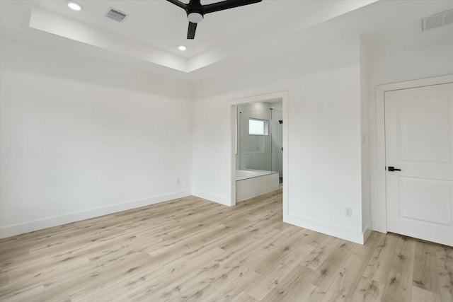 6319 Ivyknoll Dr, Houston, TX 77035 - empty room featuring ceiling fan, baseboards, light wood-style floors, recessed lighting, and a tray ceiling