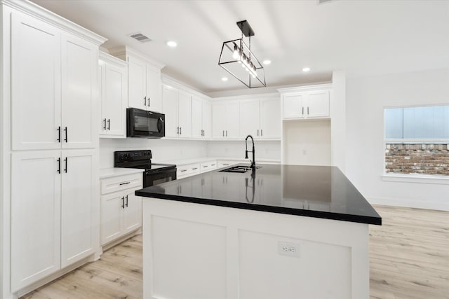 6319 Ivyknoll Dr, Houston, TX 77035 - kitchen featuring black appliances, a sink, light wood-style flooring, white cabinetry, and recessed lighting