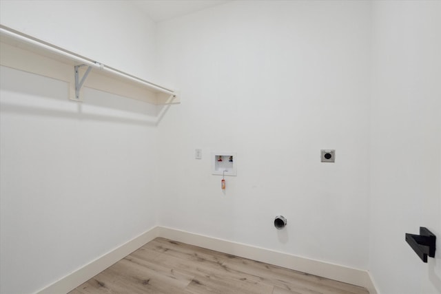 6319 Ivyknoll Dr, Houston, TX 77035 - laundry area featuring hookup for a washing machine, light wood-type flooring, baseboards, and hookup for an electric dryer