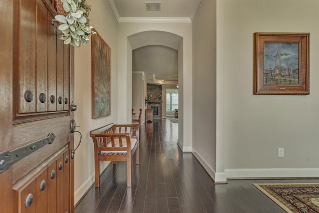 271 Spotted Saddle Ct, The Woodlands, TX 77382 - corridor featuring baseboards, crown molding, dark wood-type flooring, visible vents, and arched walkways