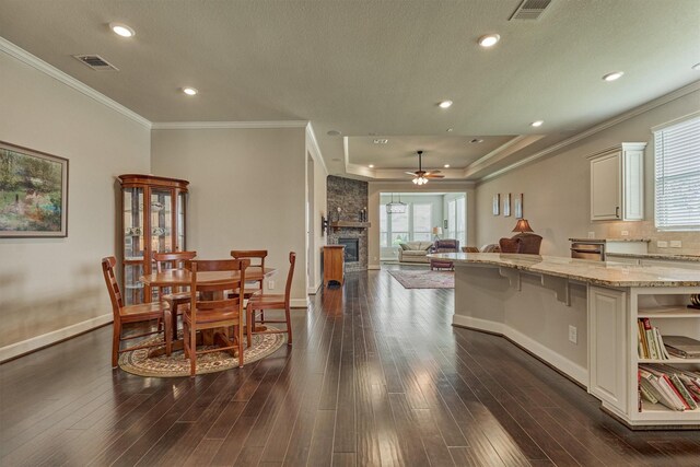 271 Spotted Saddle Ct, The Woodlands, TX 77382 - dining area featuring visible vents, baseboards, a stone fireplace, a ceiling fan, and recessed lighting