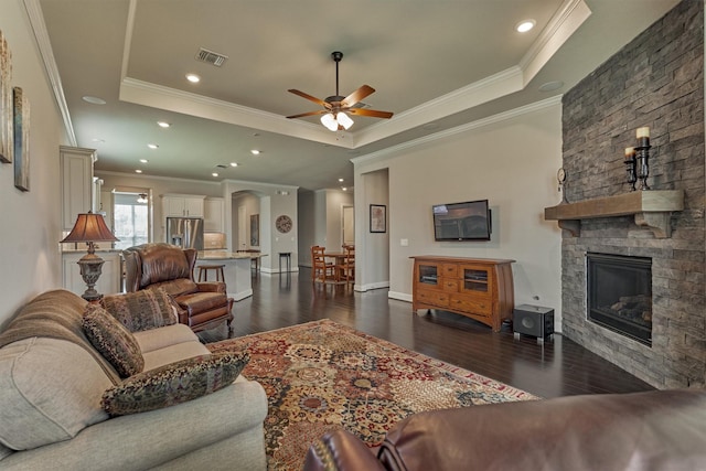 271 Spotted Saddle Ct, The Woodlands, TX 77382 - living area featuring ceiling fan, visible vents, a raised ceiling, ornamental molding, and dark wood-style floors