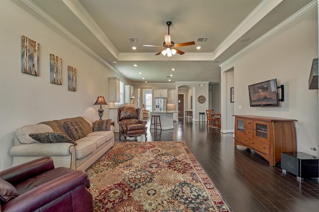 271 Spotted Saddle Ct, The Woodlands, TX 77382 - living room featuring crown molding, dark wood-type flooring, a tray ceiling, a ceiling fan, and visible vents