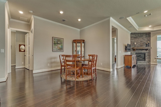 271 Spotted Saddle Ct, The Woodlands, TX 77382 - dining room featuring wood finished floors, visible vents, baseboards, and a stone fireplace
