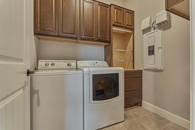271 Spotted Saddle Ct, The Woodlands, TX 77382 - laundry room with light tile patterned floors, baseboards, cabinet space, and washer and clothes dryer