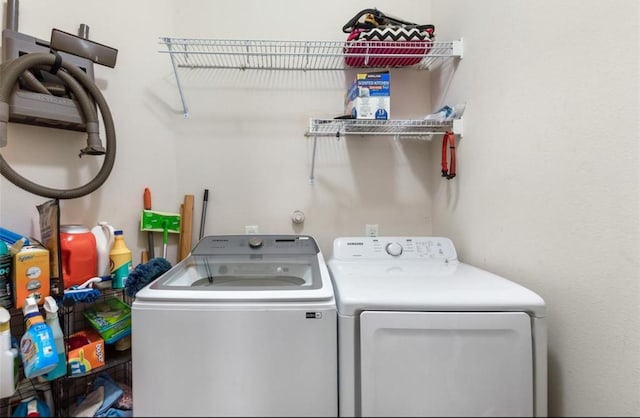 laundry room featuring separate washer and dryer and laundry area