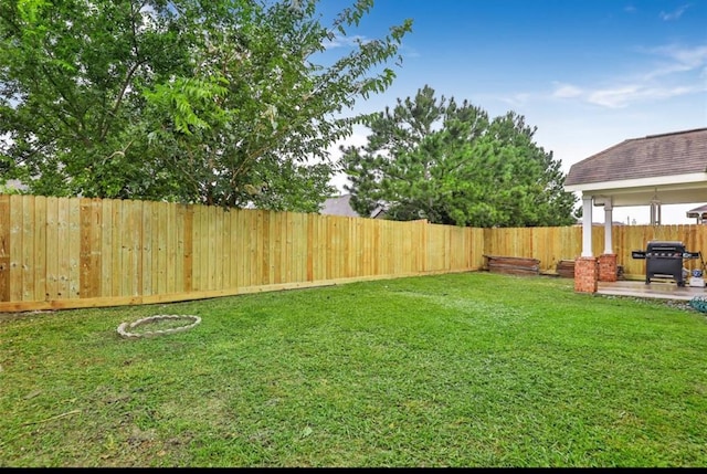 view of yard featuring a patio and a fenced backyard