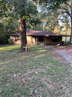 view of yard with a carport, an outbuilding, and a pole building