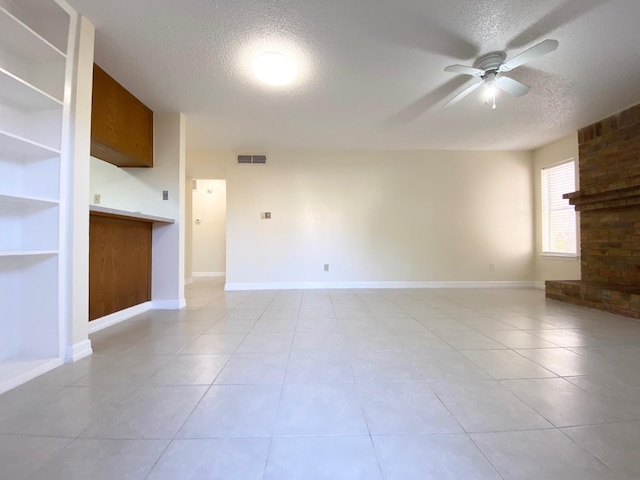 10555 Turtlewood Ct Unit 2102, Houston, TX 77072 - unfurnished living room with visible vents, a ceiling fan, light tile patterned flooring, and a textured ceiling