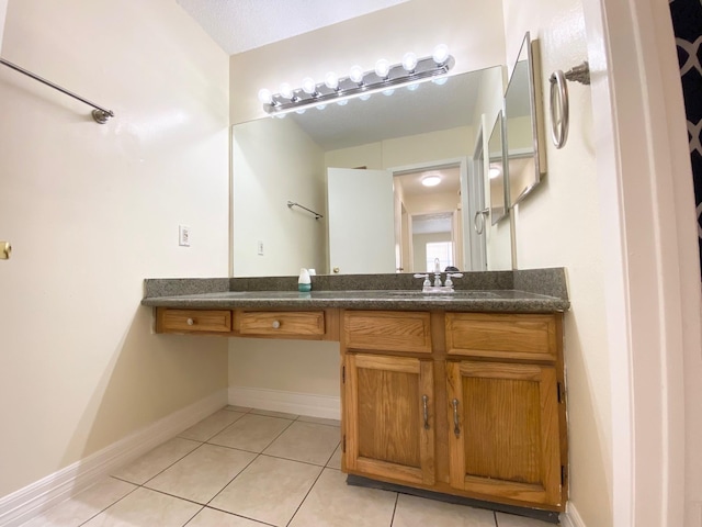 10555 Turtlewood Ct Unit 2102, Houston, TX 77072 - bathroom featuring vanity, baseboards, and tile patterned flooring