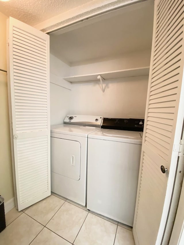 10555 Turtlewood Ct Unit 2102, Houston, TX 77072 - washroom with laundry area, light tile patterned floors, and washer and clothes dryer