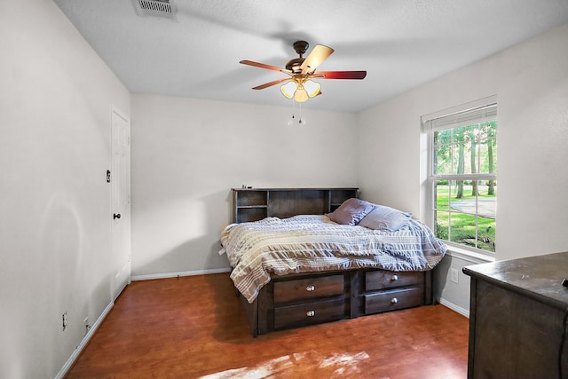 bedroom with visible vents, baseboards, and a ceiling fan
