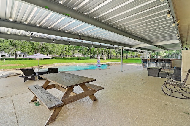 surrounding community with a patio, outdoor dry bar, outdoor dining area, and a lawn