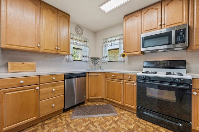 kitchen with light countertops, a sink, and appliances with stainless steel finishes