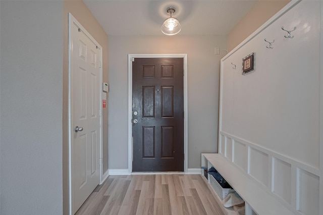 interior space featuring baseboards and light wood-style flooring