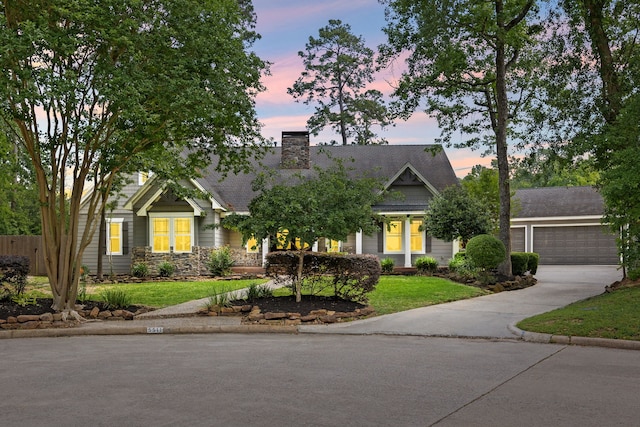 5511 Oak Cove Dr, Kingwood, TX 77345 - view of front facade with stone siding, a front yard, and concrete driveway