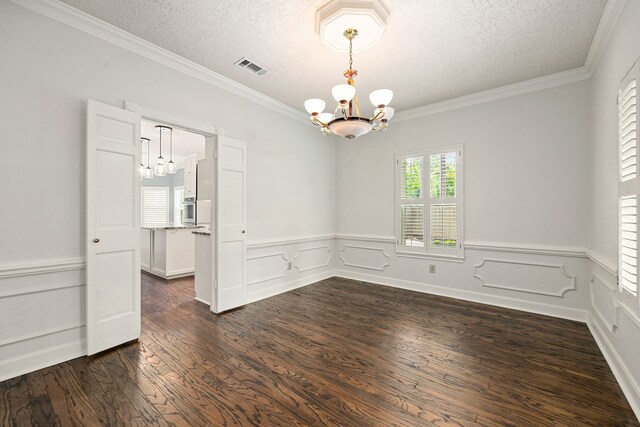 5511 Oak Cove Dr, Kingwood, TX 77345 - spare room with a notable chandelier, a textured ceiling, and dark wood-style floors