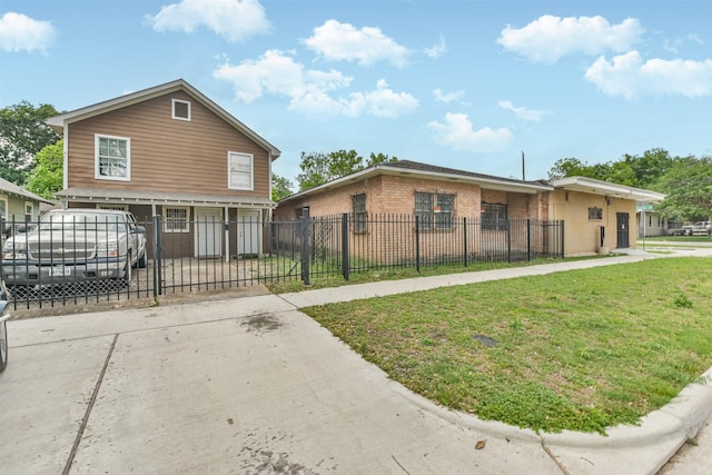7846 Dayton St, Houston, TX 77012 - view of front of home featuring brick siding, a front lawn, concrete driveway, and a fenced front yard