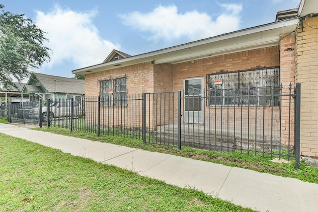 7846 Dayton St, Houston, TX 77012 - view of side of home with brick siding and a fenced front yard
