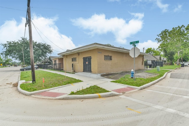 7846 Dayton St, Houston, TX 77012 - view of front of house with brick siding, a front lawn, and fence