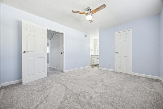 unfurnished bedroom with carpet flooring, visible vents, baseboards, ceiling fan, and connected bathroom