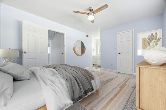 bedroom featuring connected bathroom, ceiling fan, baseboards, and visible vents