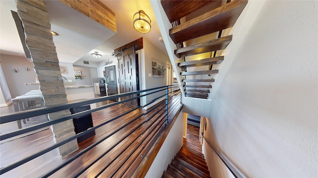12500 Melville Dr Unit 211, Montgomery, TX 77356 - stairs with ornate columns and wood finished floors