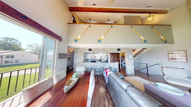 12500 Melville Dr Unit 211, Montgomery, TX 77356 - living room featuring beam ceiling, wood finished floors, a towering ceiling, and stairway
