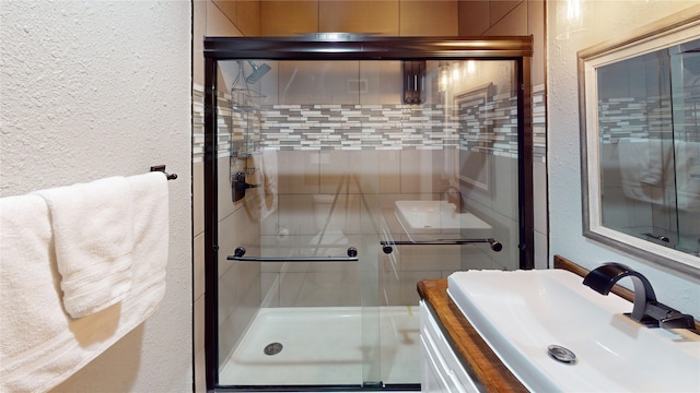 12500 Melville Dr Unit 211, Montgomery, TX 77356 - bathroom featuring a textured wall, a shower stall, and vanity