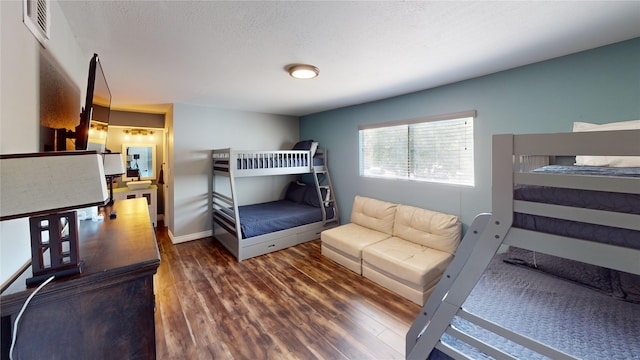 12500 Melville Dr Unit 211, Montgomery, TX 77356 - bedroom featuring wood finished floors and a textured ceiling